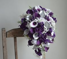 a bridal bouquet sitting on top of a wooden chair