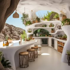 an outdoor kitchen with potted plants on the walls and counter tops, along with stools