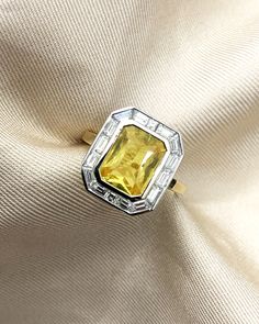 Art Deco inspired yellow sapphire engagement ring with an 18K yellow gold band and a halo of baguette cut diamonds Sapphire Art Deco Ring, Yellow Sapphire Ring Engagement, The World Is Your Oyster, World Is Your Oyster, Ruby Necklace Pendant