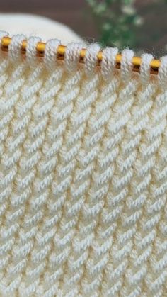 a close up view of the side of a piece of fabric with yellow stitching