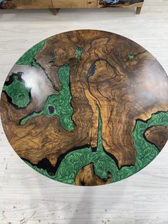 a wooden table with green and black designs on it