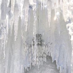 an ice cave with icicles hanging from it's ceiling and water dripping off the walls