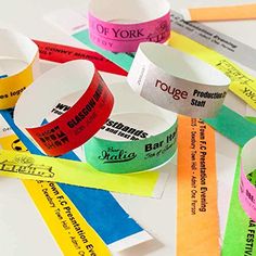 several different colored wristbands on top of each other with words written on them