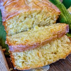 two slices of banana bread sitting on top of a cutting board next to some leaves