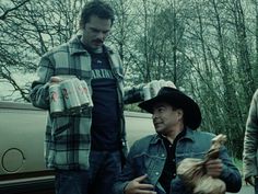 three men standing next to each other with cans in their hands and one holding food