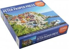 a puzzle box with the image of a town on top of a hill next to the ocean