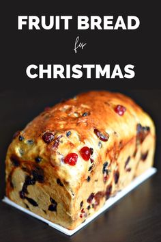 a loaf of fruit bread sitting on top of a white plate with text overlay