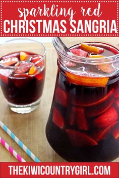 two glasses filled with sangria sitting on top of a wooden table