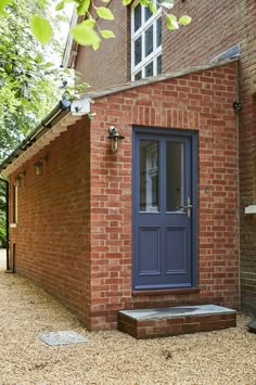 a brick building with a blue front door