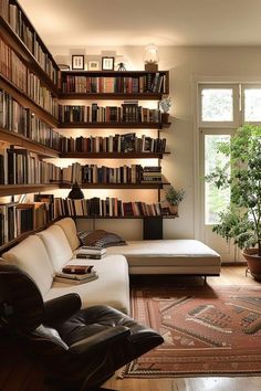 a living room filled with furniture and lots of books on the shelves next to a window