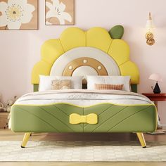 a bed with a yellow bow tie on it's headboard and foot board