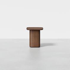 a wooden table sitting on top of a white floor