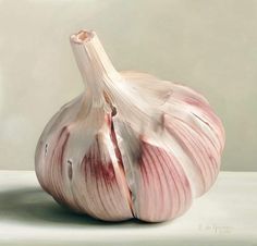 an onion on a white surface with a light gray back ground behind it and the top half peeled off