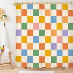 an orange, green, yellow and blue checkered shower curtain in a child's room