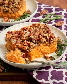 two white plates topped with slices of sweet potato casserole