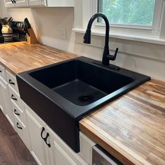 a kitchen sink sitting on top of a wooden counter