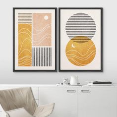 two framed art prints hanging on the wall above a white chair in a living room