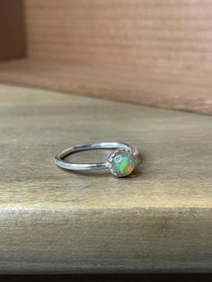 Minimalist sterling silver ring with 6mm opal on plain band size 6.5.  As with all sterling silver, it will need polished over time, but doing so will make them look good as new! This is a handmade item by me and not factory produced. Silver Opal Ring, Plain Bands, Opal Ring, Opal Rings, Stackable Rings, Sterling Silber, Sterling Silver Ring, Favorite Jewelry, Sterling Silver Rings