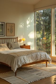 a bed sitting in a bedroom next to a window filled with lots of windows and furniture