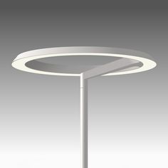 a white table with a circular light on it