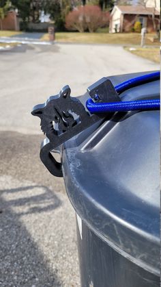 a close up of a blue hose connected to a trash can