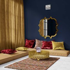 a living room with blue walls and gold accents