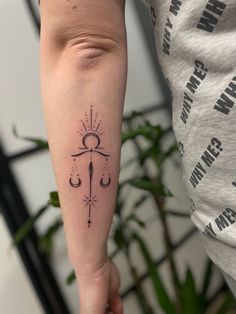 a woman's arm with a tattoo on it and a candle in the middle