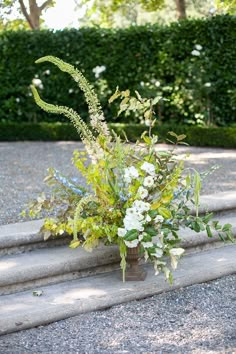 a vase filled with flowers sitting on top of steps