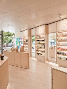 the inside of a store with shelves and counter tops filled with cosmetics products on display