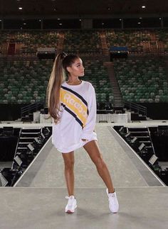 a woman standing on top of a tennis court holding a racquet in her hand