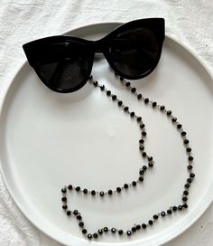 Sunglasses chain from a unique rosario with black beads and gold chain. You can put it in every pair of sunglasses that you wish. In Christina Christi Jewels store you can see a lot of fashion accessories for men and women. You can have them in 2-4 Days with DHL EXPRESS SHIPPING - Rosario Chain with black beads and gold chain that is made from metal. - You can choose in three different dimensions for your glasses. (70 - 80 - 90 cm) # FIND ALL MY DESIGNS IN GLASSES CHAINS HERE: https://etsy.me/2W Black Glass Round Bead Jewelry, Black Glass Round Beads Jewelry, Black Glass Beaded Jewelry, Black Beaded Glass Necklaces, Black Beaded Glass Necklace, Adjustable Black Beaded Glasses Chains, Adjustable Beaded Black Glasses Chains, Elegant Black Glasses Chains For Party, Black Adjustable Glasses Chain For Parties