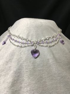 Elegant and dainty necklace made using violet Swarovski bicone beads and featuring three violet Swarovski heart pendants. Necklace is 19.5 inches long, with a lobster clasp closure. Crystal Double Heart Necklaces For Wedding, Crystal Double Heart Jewelry For Wedding, Crystal Heart Pendant Necklace For Party, Crystal Heart Cut Jewelry With Heart Charm, Valentine's Day Crystal Jewelry With Sparkling Stones, Valentine's Day Party Crystal Heart Necklace, Party Crystal Heart Pendant Necklace, Crystal Heart Jewelry With Heart Charm, Crystal Heart Pendant Necklace For Wedding