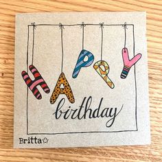 a birthday card hanging on a clothes line with the words britta written in it