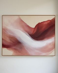 an abstract painting hangs on the wall