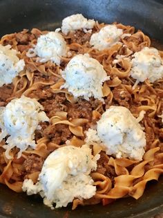 a skillet filled with pasta, meat and cheese