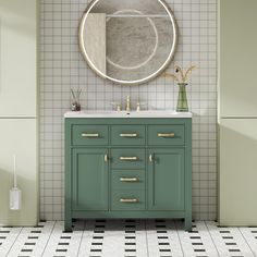 a bathroom with green cabinets and a round mirror