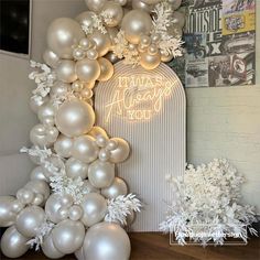 white balloons and snowflakes are on display in front of a wall with a sign that says, i was always you