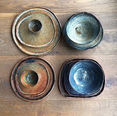 four bowls sitting on top of a wooden table