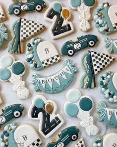 decorated cookies are arranged in the shape of race cars and racing driver's hats