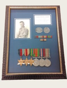 a framed photo with medals and pictures on it