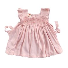 This lovely short-sleeved dress is made from 100% cotton gauze fabric, which is lightweight, airy, slightly crinkled and great for a casual look. It has very special color: light pink sand color, with intricate smocked and embroidered as usual. Comfortable, perfect for everyday wear and outgoing activities. * 100% Cotton * 100% Handmade * Tie at the back * Lightweight, soft cotton, comfortable, and ready to play * Hand wash or machine wash on a delicate setting We are based in Sydney, New South Summer Cotton Smocked Dress With Flutter Sleeves, Pink Cotton Sundress With Smocked Back, Breezy Pink Ruffled Dress, Pink Linen Ruffled Dress, Pink Breezy Dress With Ruffles, Summer Sundress With Ruffles And Short Sleeves, Summer Sundress With Short Sleeves And Ruffles, Breezy Pink Dress With Ruffles, Cotton Smocked Summer Dress