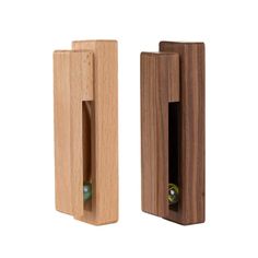 a wooden door handle with a green ball in the center and an opening on the outside