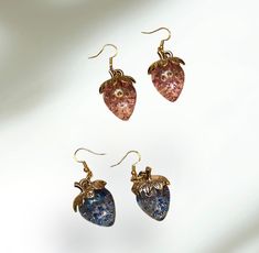 These beautiful shiny strawberry earrings come in blue or pink with gold details. Adds something unique to any outfit!  Sizing: large strawberry charm. 1 inch long and 3/4 inches wide.