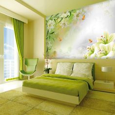 a green bedroom with white flowers on the wall