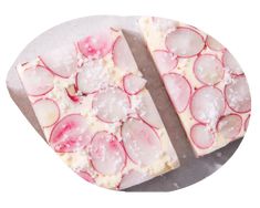 two slices of pizza with radishes on them