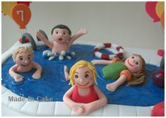 a birthday cake with children swimming in the pool