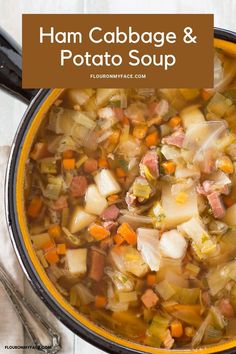 ham cabbage and potato soup in an orange bowl with spoons on the side, text overlay reads ham cabbage and potato soup