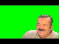 a man with a moustache on his face in front of a green screen