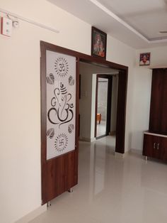 an open door leading into a room with white tile flooring and wood trimming