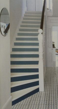 a hallway with blue and white striped stairs